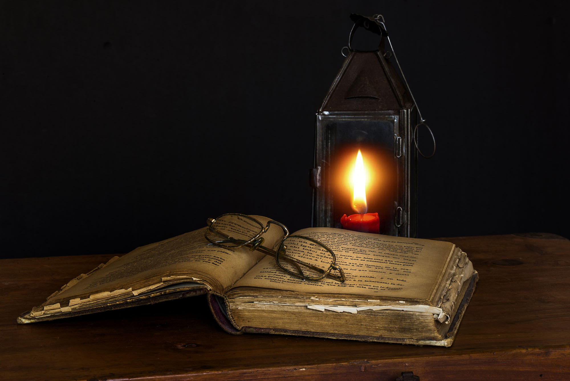 Old tome lit by a lantern