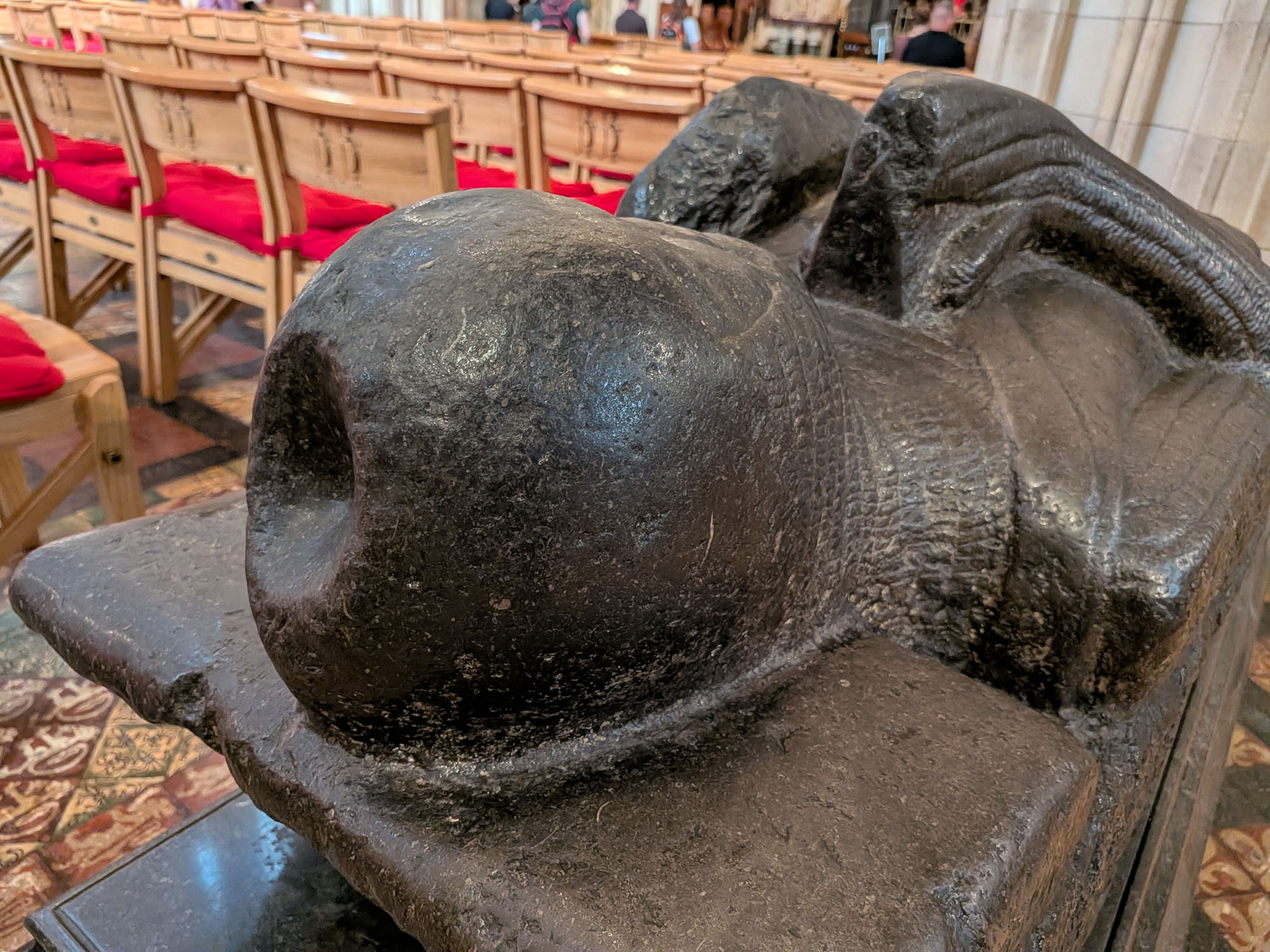 Close-up detail of the head of Strongbow's effigy. A large, concave dent is present on the top of his head.